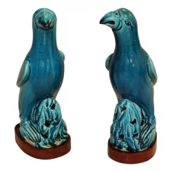 Pair of parrots standing on an openwork rock, in porcelain …
